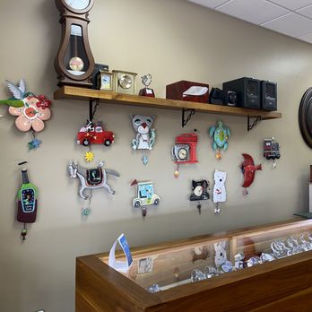 Image of the inside view of the physical Cote Timework store, the left wall with novelty clocks hanging on the wall.
